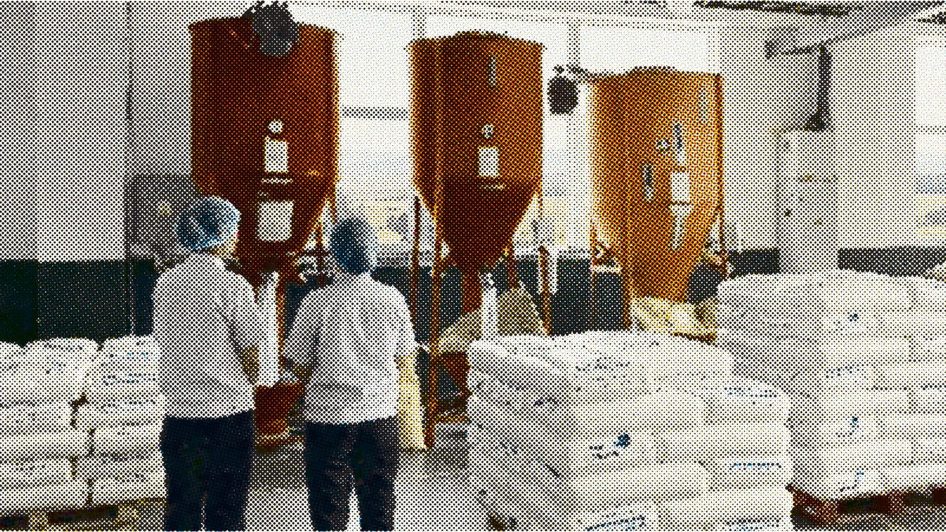 Workers standing in front of industrial machinery