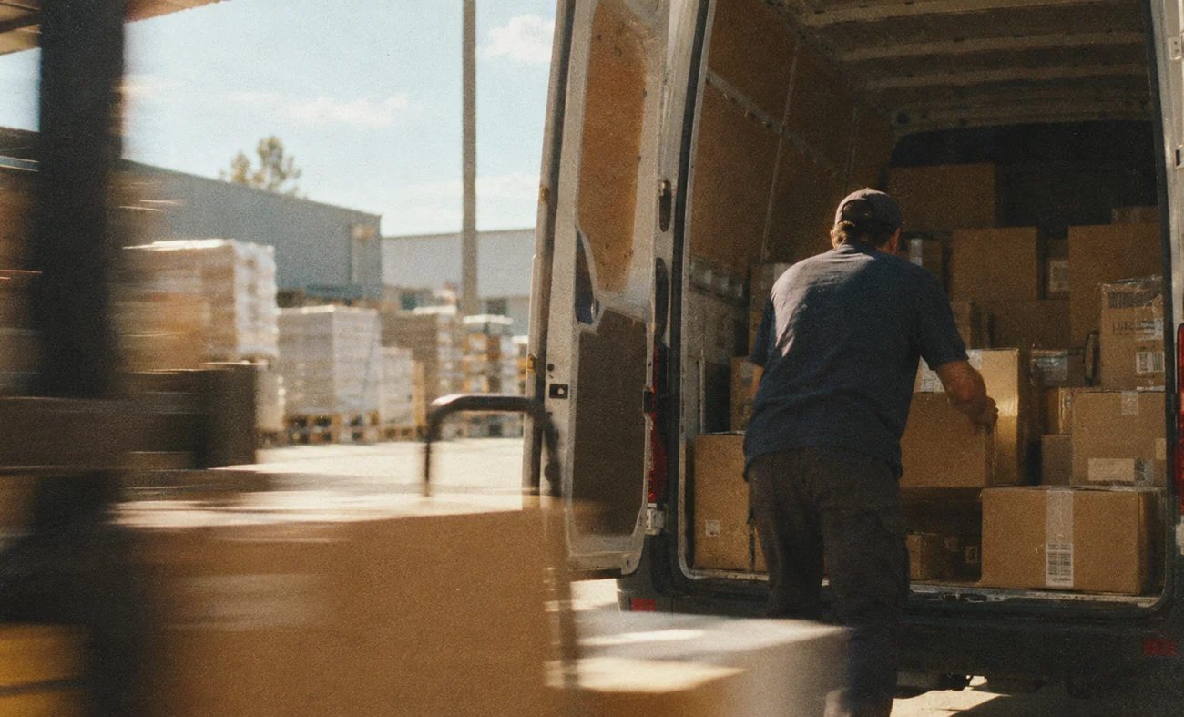 Warehouse workers and boxes in motion, illustrating the physical operations Paloma runs on